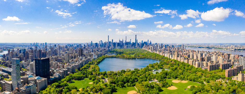 Central Park aerial view, Manhattan, New York. Park is surrounded by skyscraper. Beautiful view of the Jacqueline Kennedy Onassis Reservoir in the center of the park.