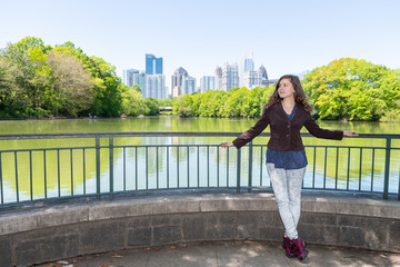 Atlanta, Georgia cityscape in Piedmont Park view green trees urban city skyscrapers with happy...