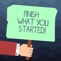 Text sign showing Finish What You Started. Conceptual photo Do not stop until accomplish your goals Persistence Hu analysis Hand Holding Blank Colored Placard with Stick photo Text Space