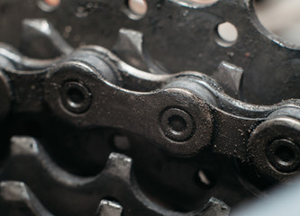 Dirty mountain bike chain on sprocket. Bicycle maintence. Mechanics shop