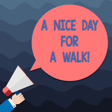 Text sign showing A Nice Day For A Walk. Conceptual photo Good weather to go outside leisure free relaxing time Hu analysis Hand Holding Megaphone Blank Round Color Speech Bubble photo