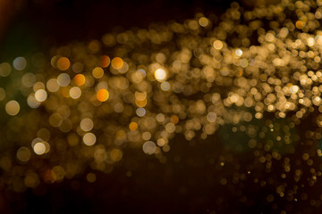 Gold blur bokeh defocused on black