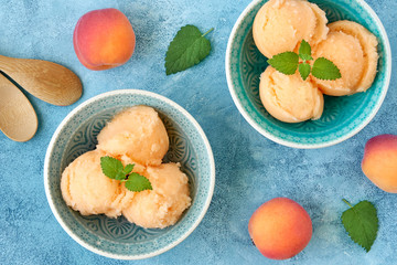 Homemade apricot ice cream , sorbet with ripe apricots and mint leaves. Top view