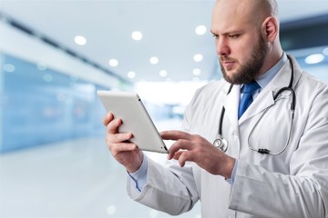 Young man doctor holding x-ray