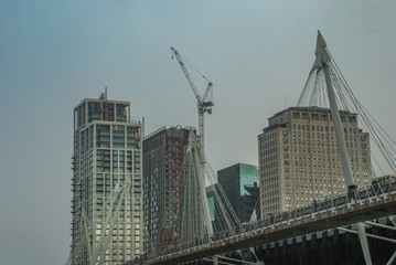 Fototapeta na wymiar Modern buildings beside the Millennium Bridge along the River Thames.