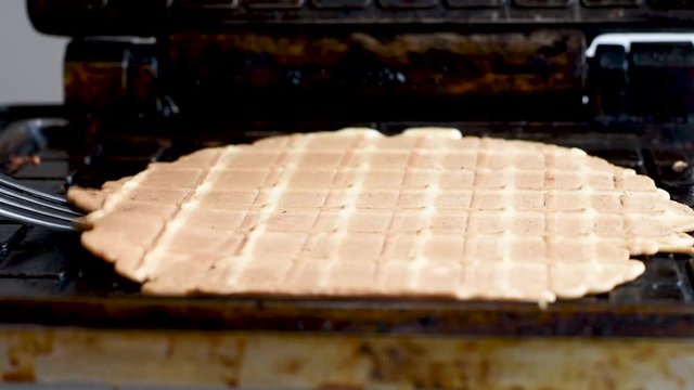 Preparation of wafers from fresh dough in a waffle maker in daylight Waffles. Making fresh hot waffles in the waffle maker for food 
