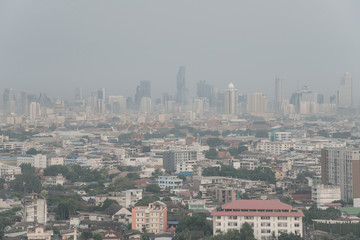 The skyline is seen through morning air pollution in Bangkok, bad air pollution it is unhealthy. Pollution is a mixture of dust, dirt, soot and smoke.