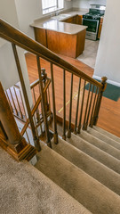 Vertical Staircase inside a house overlooking the kitchen and an empty room