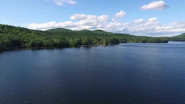 Aerial Drone shot flying over Loon Lake towards pregnant lady mountain formation in the Adirondacknew york, mountains in New York on a sunny summer day