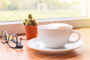 cup of coffee on wood table