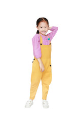 Smiling little Asian kid girl in pink-yellow dungarees poses touched hair keep back isolated on white background. Full length of kid and fashion concept.