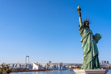 Statue of Liberty and Rainbow bridge, located at Odaiba Tokyo, Japan
