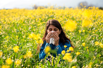 The woman polen allergy with yellow flowers.