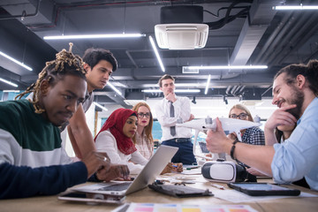 multiethnic business team learning about drone technology