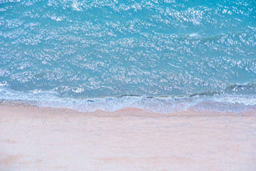 Naklejka na ściany i meble Soft beautiful ocean wave on sandy beach,Top view,Amazing nature background.