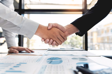 Business Meeting agreement Handshake concept, Hand holding after finishing up dealing project or bargain success at negotiation over office background.