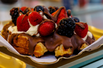 Breakfast waffles with strawberries and chocolate toppings