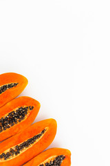 Slices of tasty papaya with copy space on white background. Flat lay. Top view.