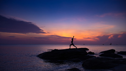 Asian girl practice Yoga on the beach Sunrise morning day