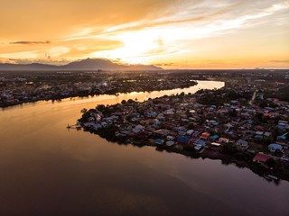 scenic aerial view of Sarawak River during sunset with Gunung (mountain) Serapi at the background