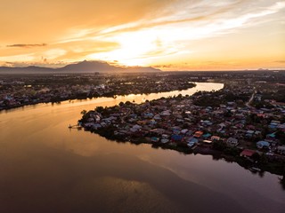 scenic aerial view of Sarawak River during sunset with Gunung (mountain) Serapi at the background