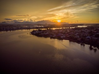 scenic aerial view of Sarawak River during sunset with Gunung (mountain) Serapi at the background