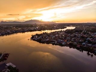scenic aerial view of Sarawak River during sunset with Gunung (mountain) Serapi at the background © MuhammadFadhli