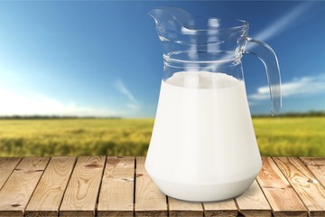 Glass of milk and bottle on  background