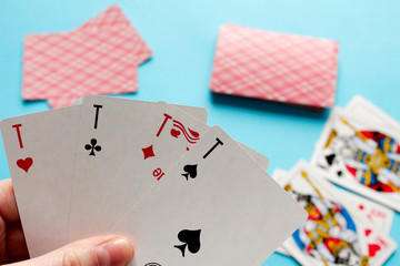 Playing card. Hand with card playing poker .close up of male hand with playing cards and chips at...