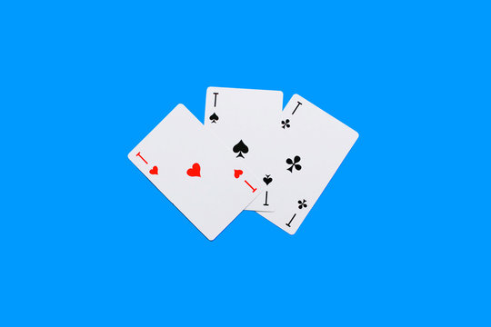 Playing card. Hand with card playing poker .close up of male hand with playing cards and chips at home. Pocker game. Casino cards as background. Concept for games, gambling in casino and sports poker.