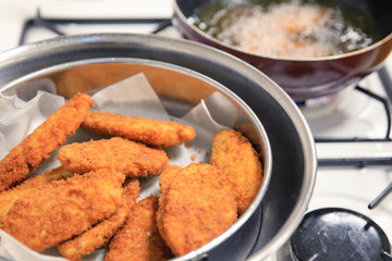Dumplings in deep fryer, closeup