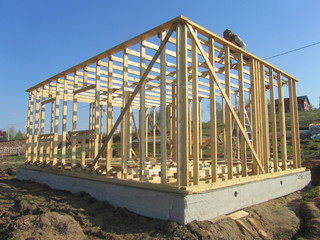 Construction home framing against blue sky.Wood frame residential building under...