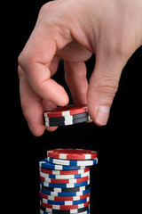 a poker player collects a stack of chips of different colors