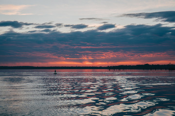 Sunset over the Water showcasing a small Dock and Buoy