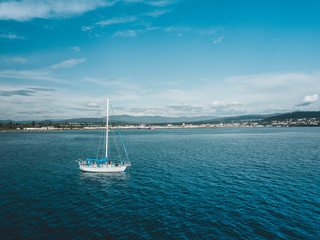 Overhead view of a Sailboat overlooking a Seaside City