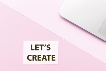 Obraz premium Phrase Let is create and laptop on pink background. Top view. Mockup, copy space.