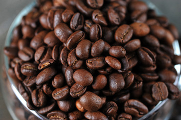 coffee beans in transparent glass Cup as a  background