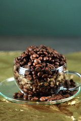 coffee beans in transparent glass Cup on gold