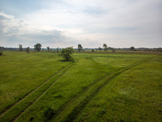 Fototapeta na wymiar Green field with road path that is split. Kiev, Ukraine