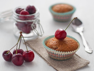 Freshly baked cupcake with cherry. Homemade pastry. Selective focus on the front.