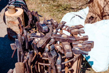 blacksmith at work. hammers in a metal basket. there are a lot of them. tool for the master.