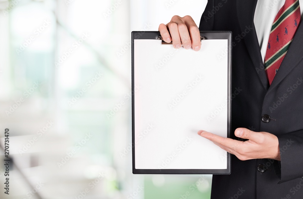 Poster Human hand holding folder with white blank paper