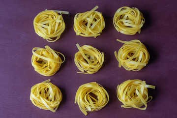 Dry pasta yellow on a dark background. Italian food