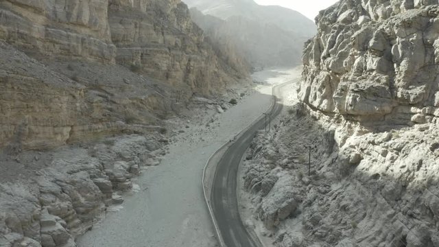 aerial of canyon with road in oman