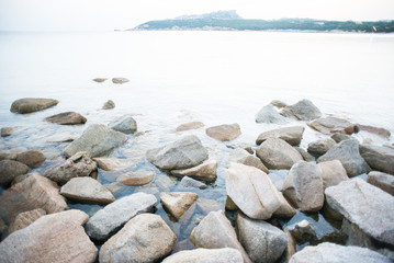Stones on Shore in La Colba Bay on North Sardinia, Italy. Beach of Rena di Ponente.