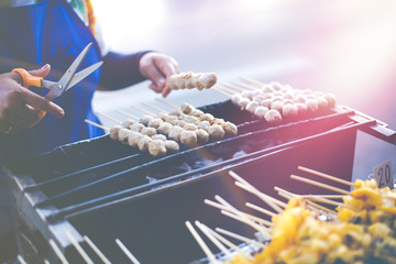 Grilled meatballs  on grill mesh delicious roasted appetizer Thai style