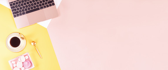 Female workspace with computer, summer yellow flowers bouquet on colorful pastel background. Flat...