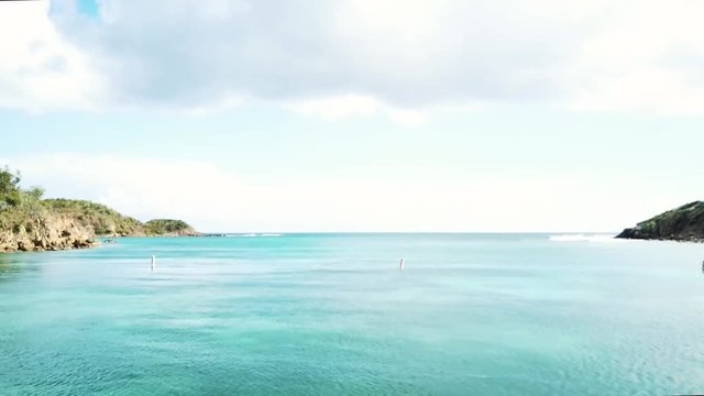Secret island bay with turquoise Caribbean ocean harbor of blue sea waves crashing in remote exotic island shore on coast of tropical Virgin Island during spring break getaway
