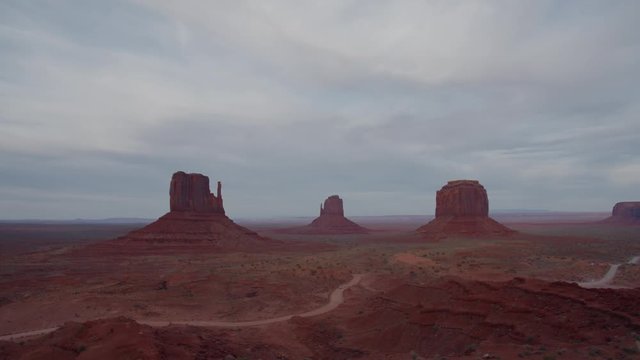 FIXED Cars passing by red rock formations in Monument Valley, Arizona, USA. 4K UHD 60 FPS SLOW MOTION