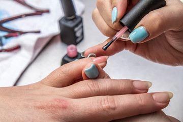 Do a manicure in a beauty salon
